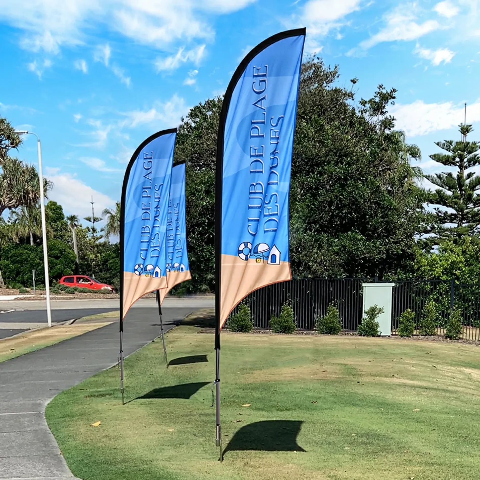 Concave flag in outdoor usage scenario, the flag fluttering in the wind atop a flagpole.