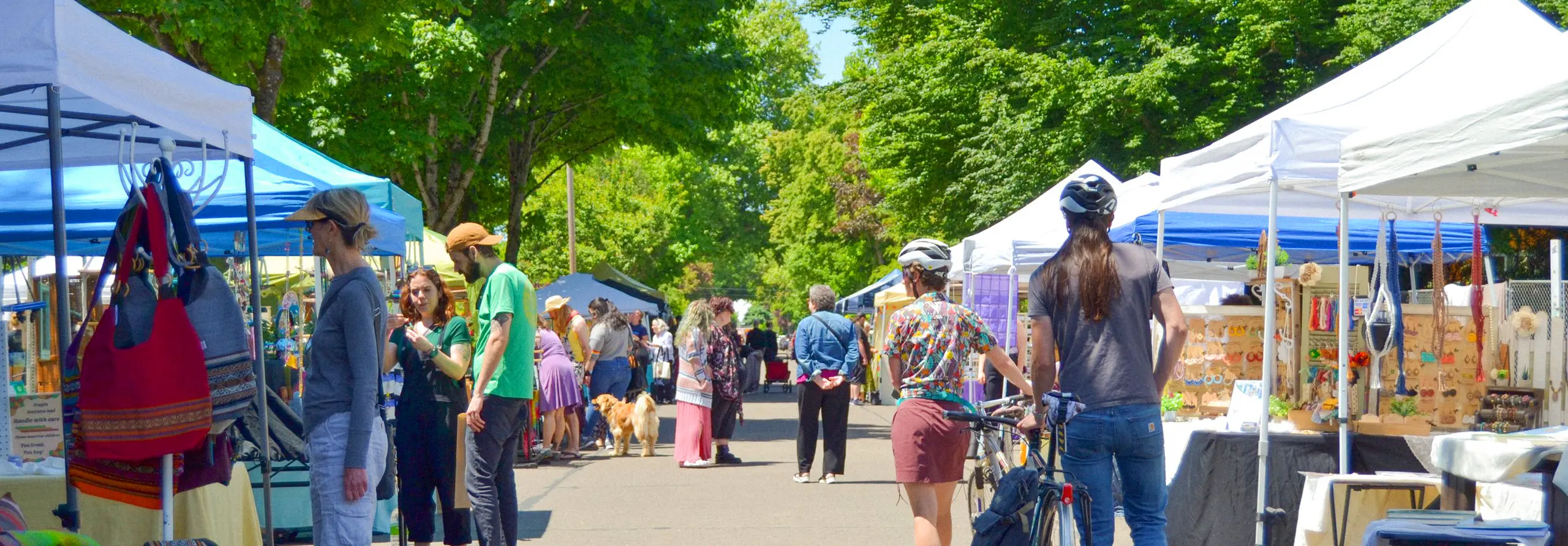 White tents were set up on both sides of the road and passersby were leisurely browsing the stalls