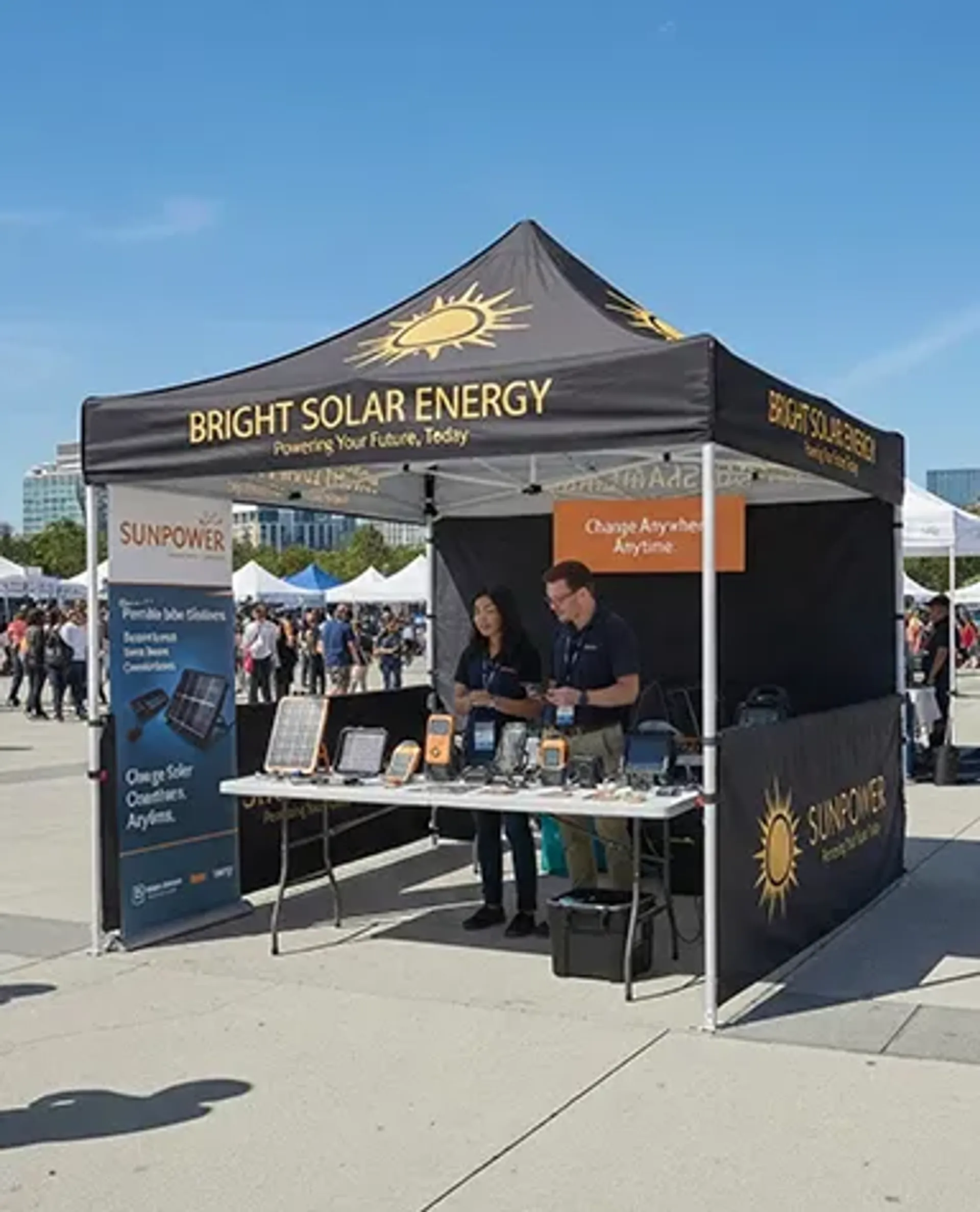 A black custom promotional canopy for "Bright Solar Energy" and "SunPower" set up at an outdoor event, featuring a branded back wall and staff showcasing portable solar panels on an event booth table.