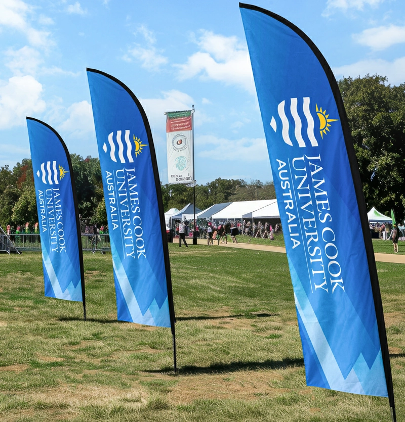 A business uses custom feather flags to promote their products at an event.