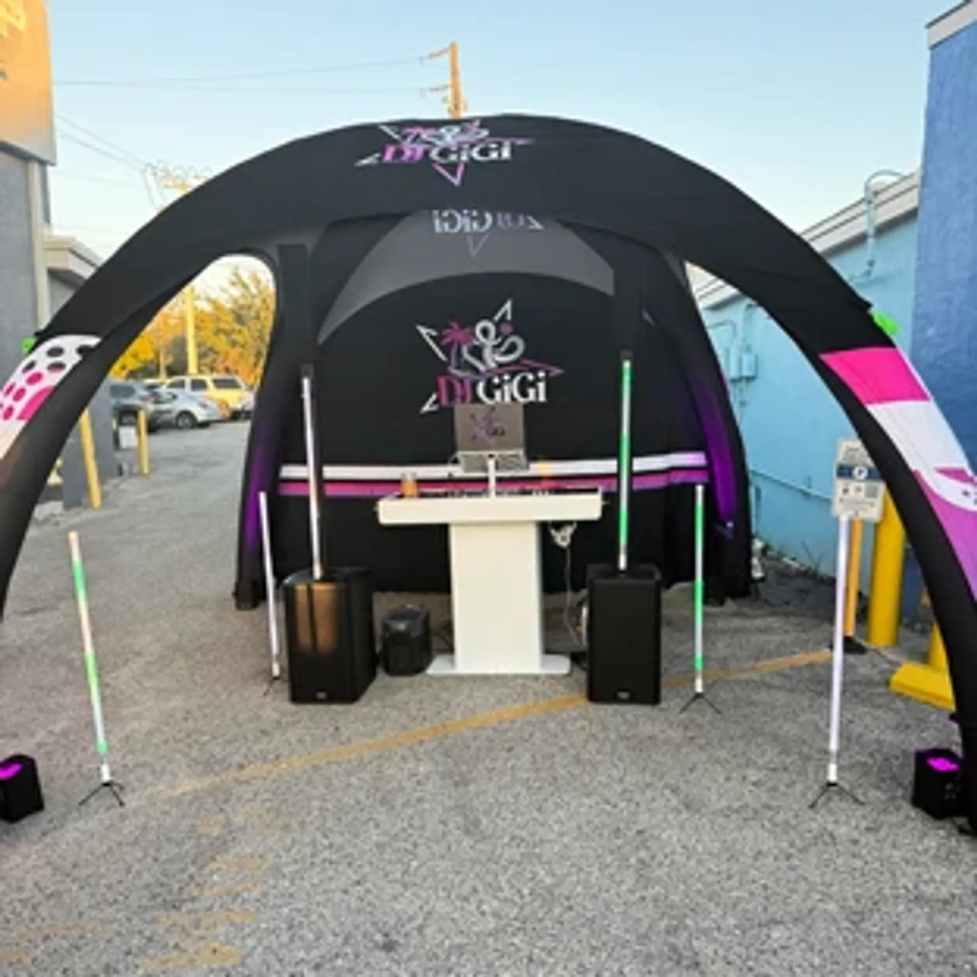 Black custom inflatable dome tent used as an outdoor DJ booth and entertainment station for a street event