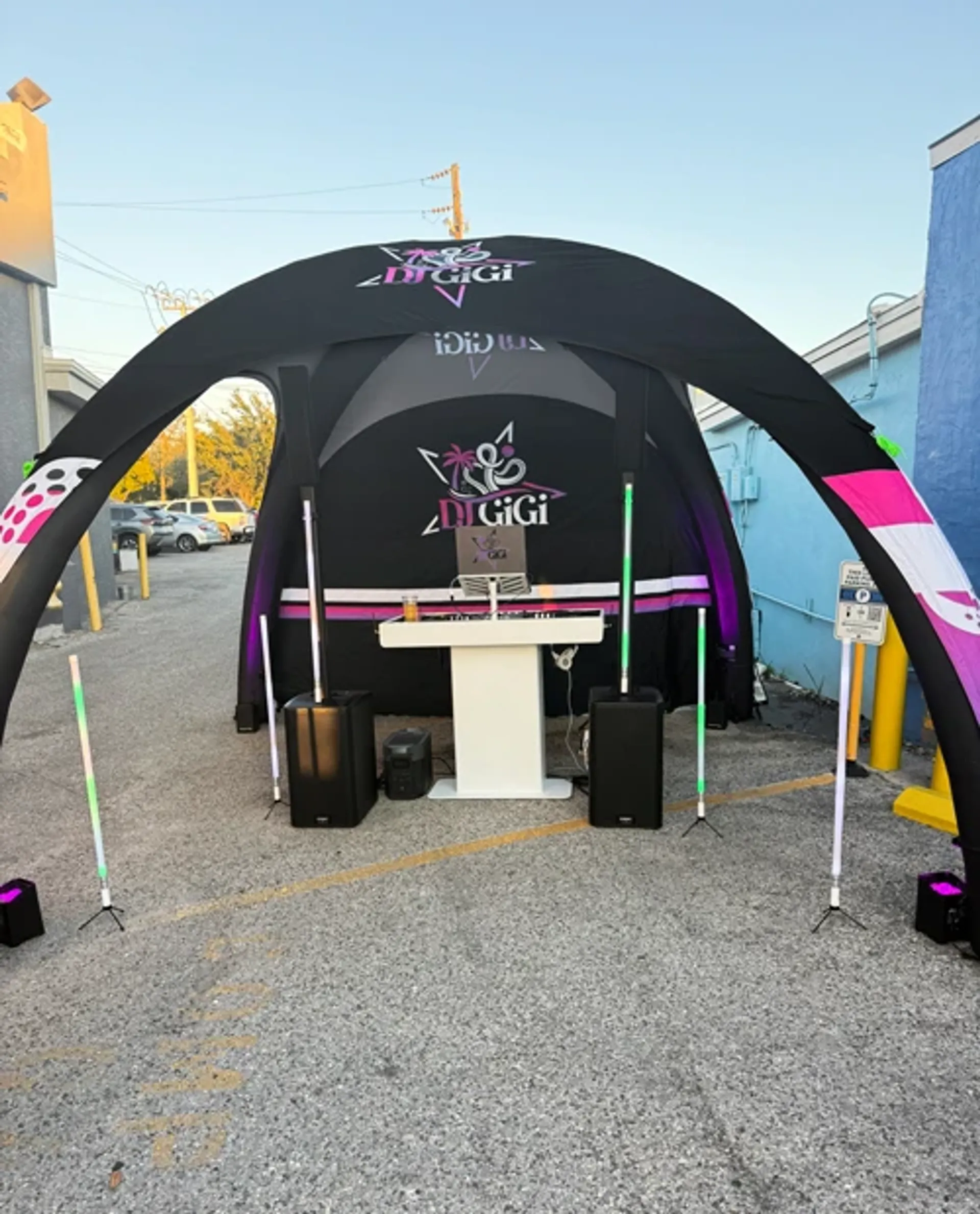 Black custom inflatable dome tent used as an outdoor DJ booth and entertainment station for a street event