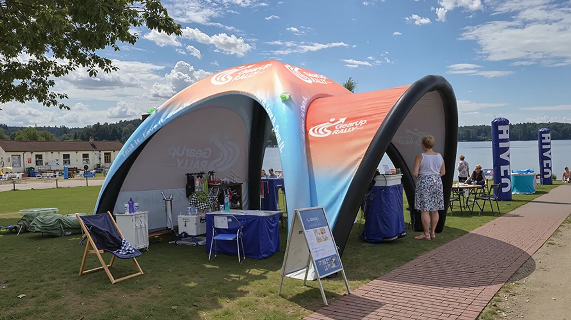 Custom printed inflatable dome tent used as an outdoor registration and information booth for a lakeside sports rally
