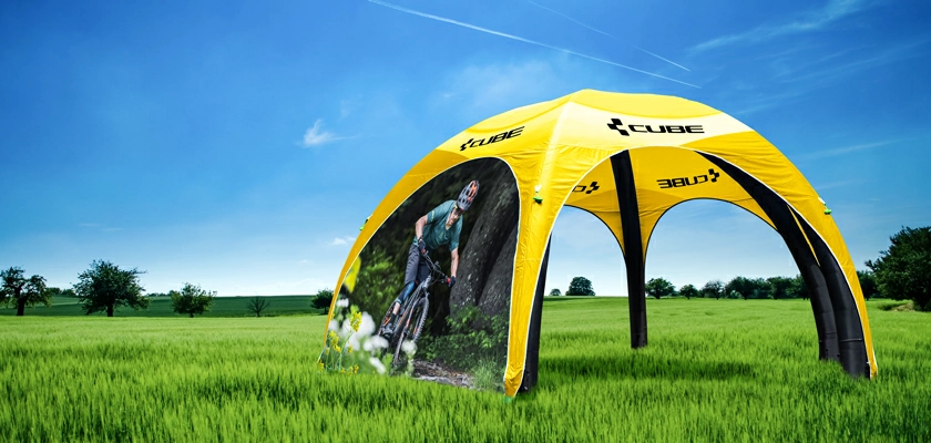 A yellow custom printed basic inflatable canopy tent with a full wall