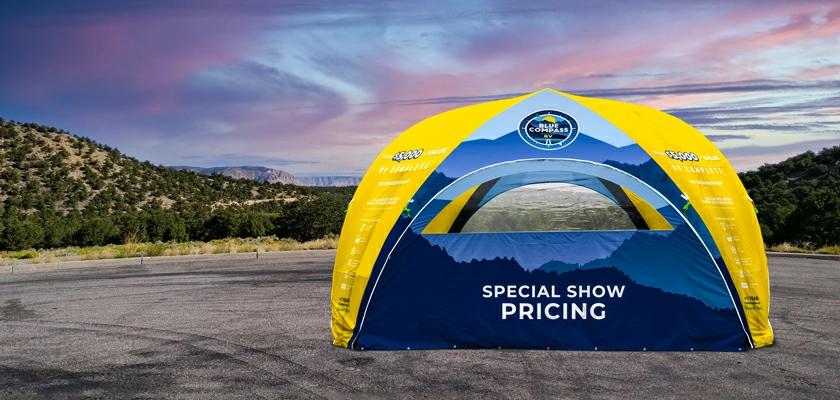A yellow custom printed plus inflatable tent with two PVC window walls