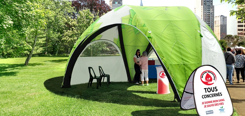 custom green plus inflatable canopy tent in the grass