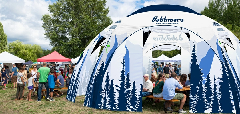 People talking in a white custom printed hexagonal inflatable tent