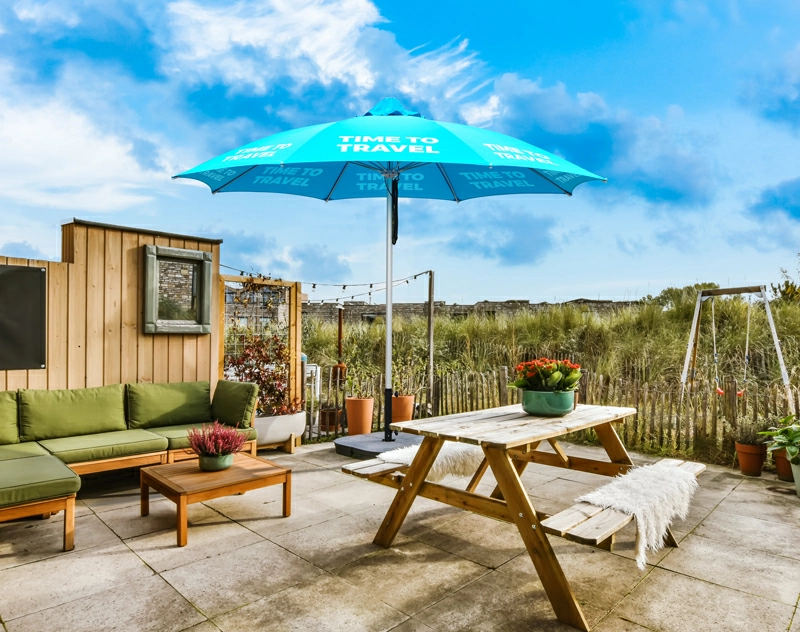 A custom dome umbrella stands in the outdoor courtyard