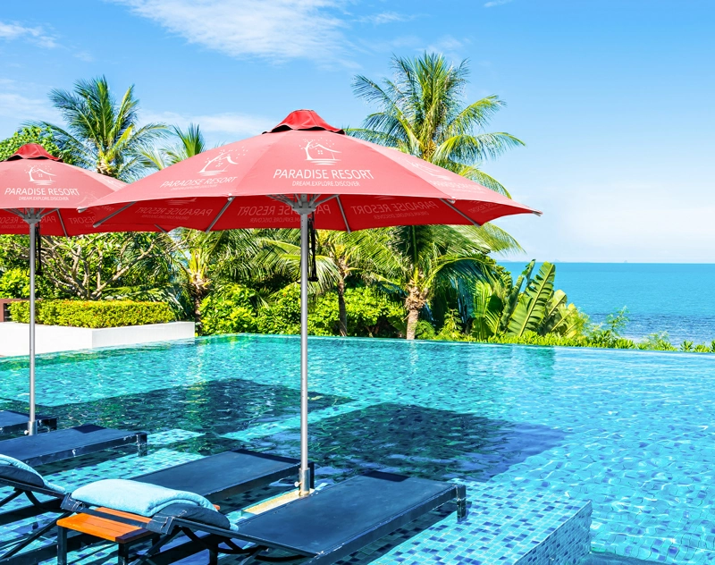 Two red customized octagonal umbrellas provide shade in the pool