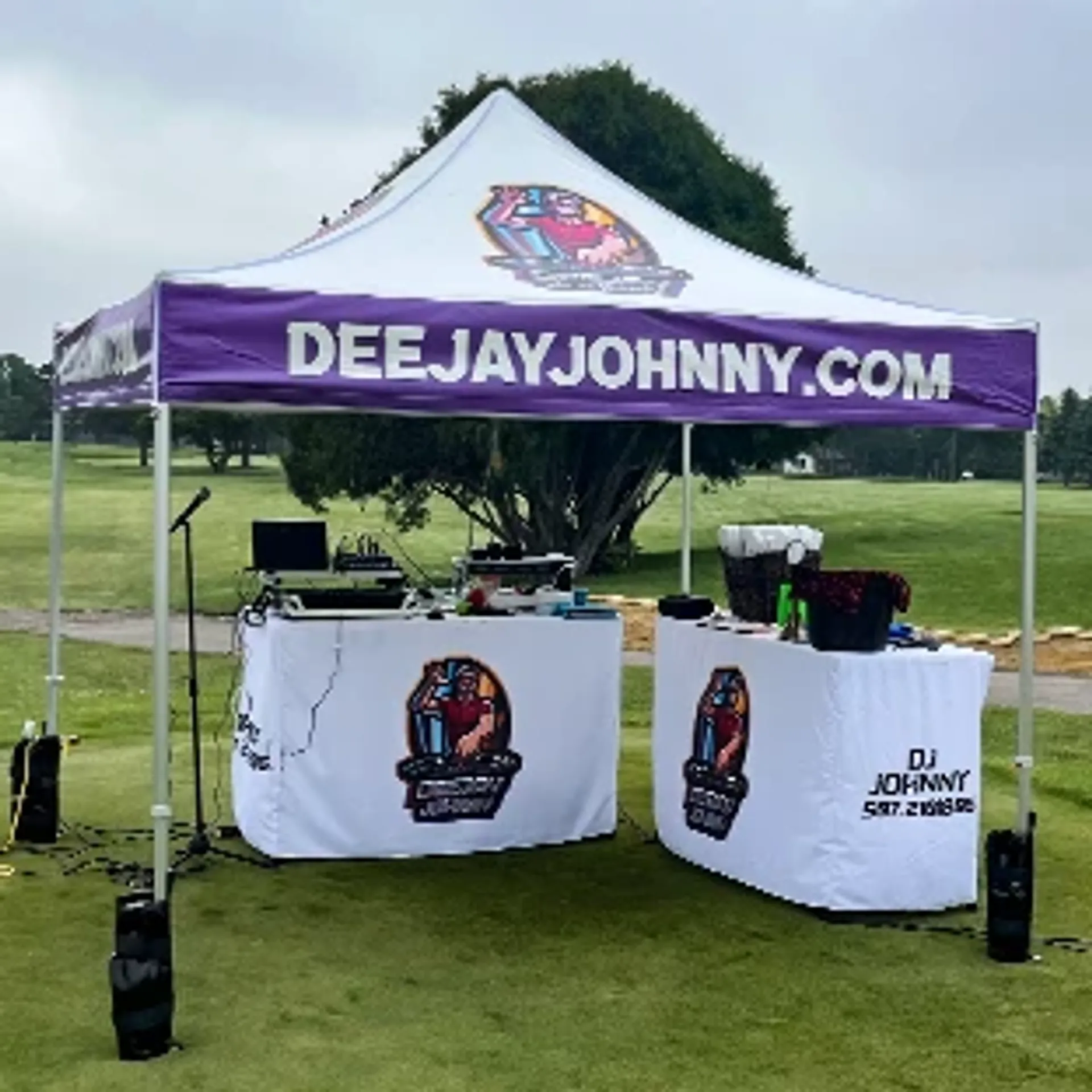Custom 10x10 pop up tent with logo and matching table covers for professional event setups.