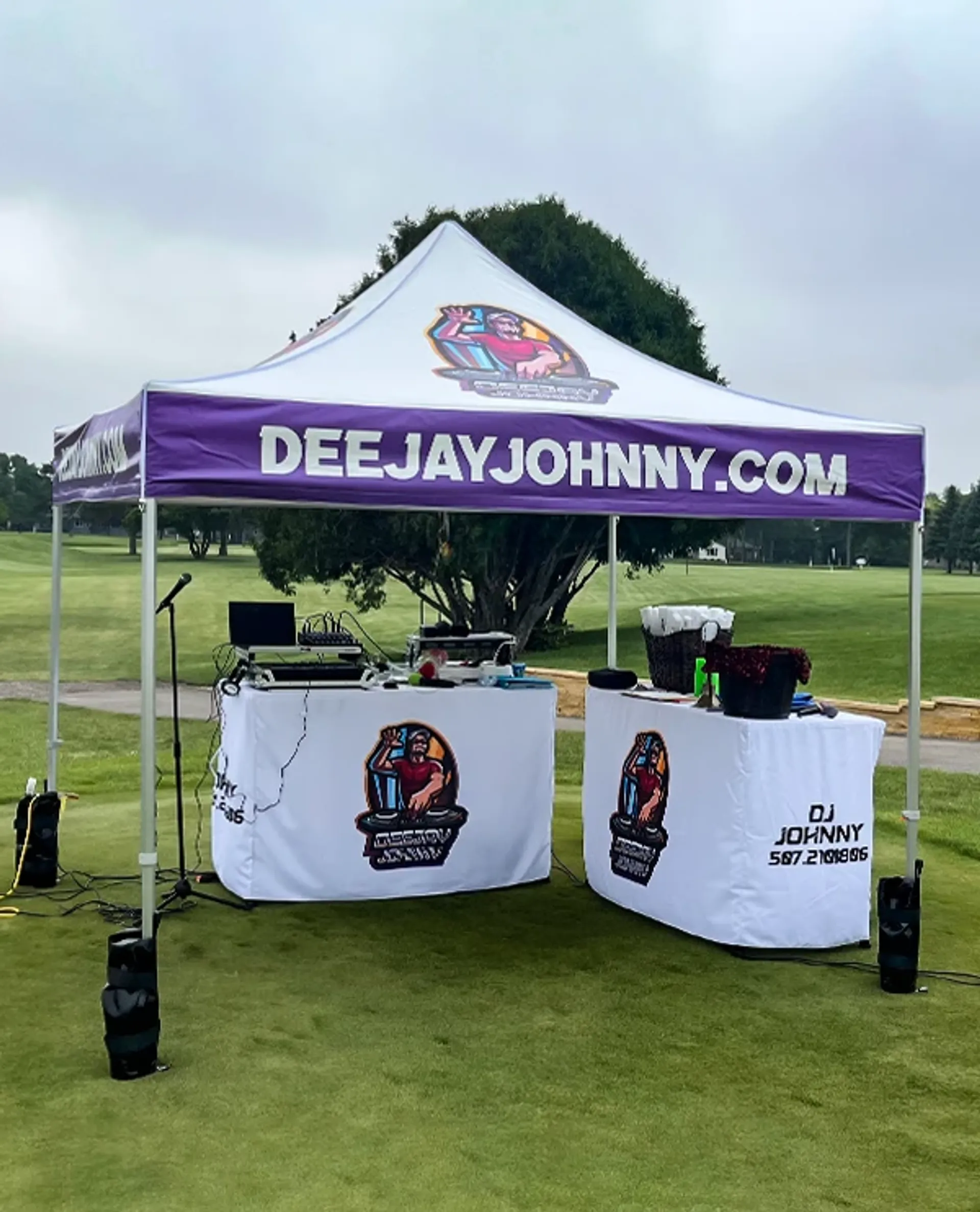 Custom 10x10 pop up tent with logo and matching table covers for professional event setups.