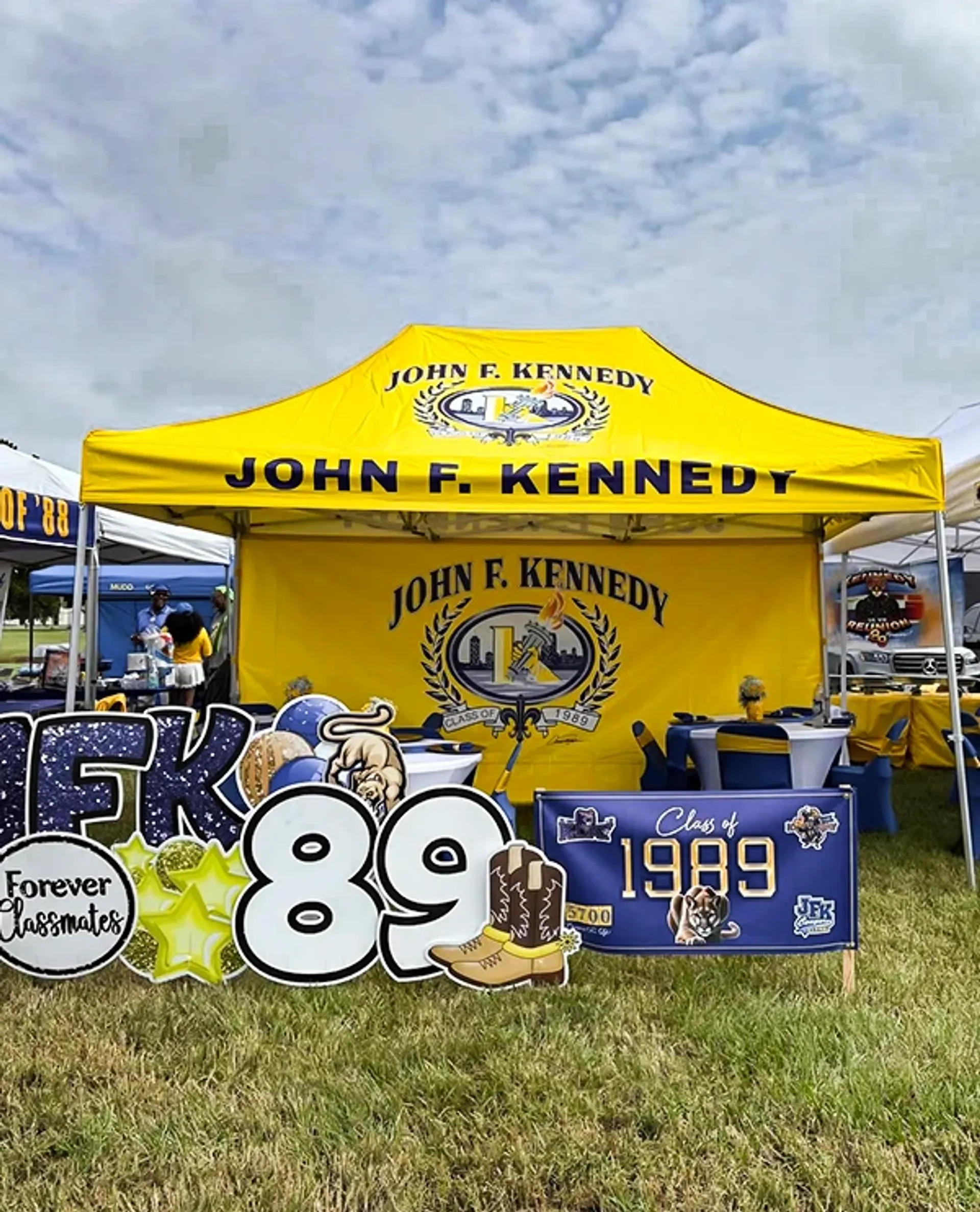 Bright yellow 10x10 logo tent for school reunions and large outdoor gatherings.