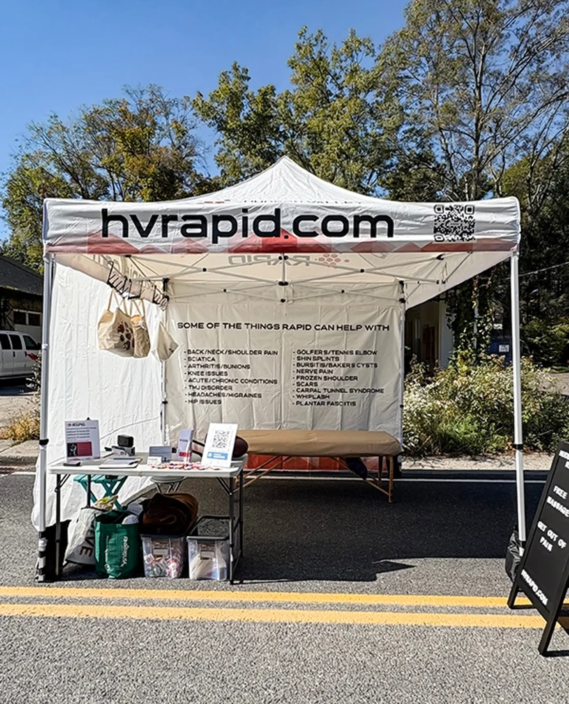 10x10 custom tent with logo and printed backwall for medical and professional services.