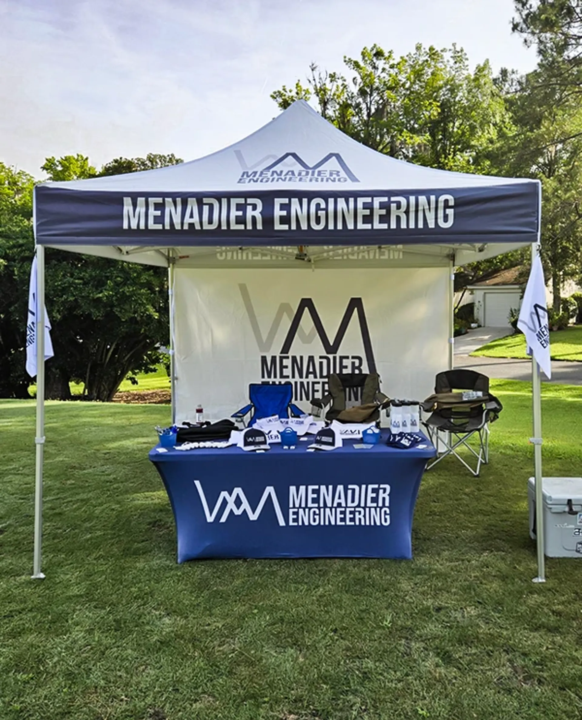 Professional branded 10x10 tent setup with backwall and logo flags for trade shows.