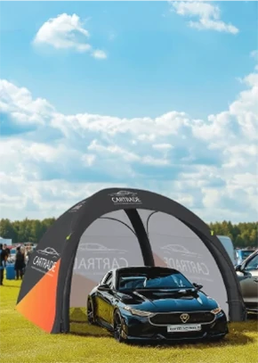 Custom inflatable dome tent used as a car display booth at an outdoor auto show.
