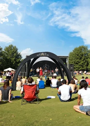 Custom inflatable dome tent set up at an outdoor music event, used as a branded stage backdrop.