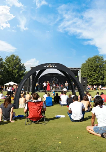 Custom inflatable dome tent set up at an outdoor music event, used as a branded stage backdrop.