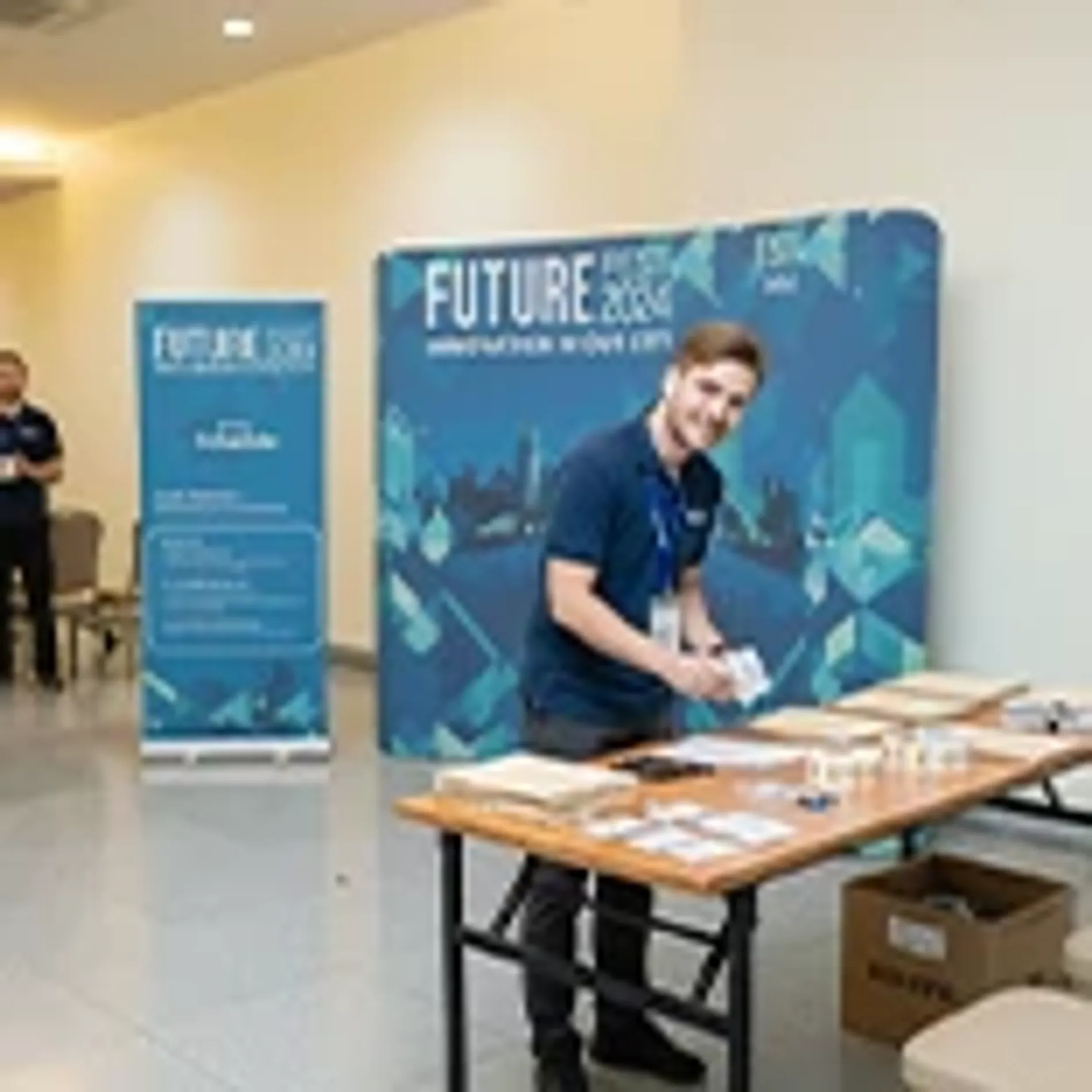 Curved branded backdrops with large-scale graphics used for promotional event branding in high-traffic areas.