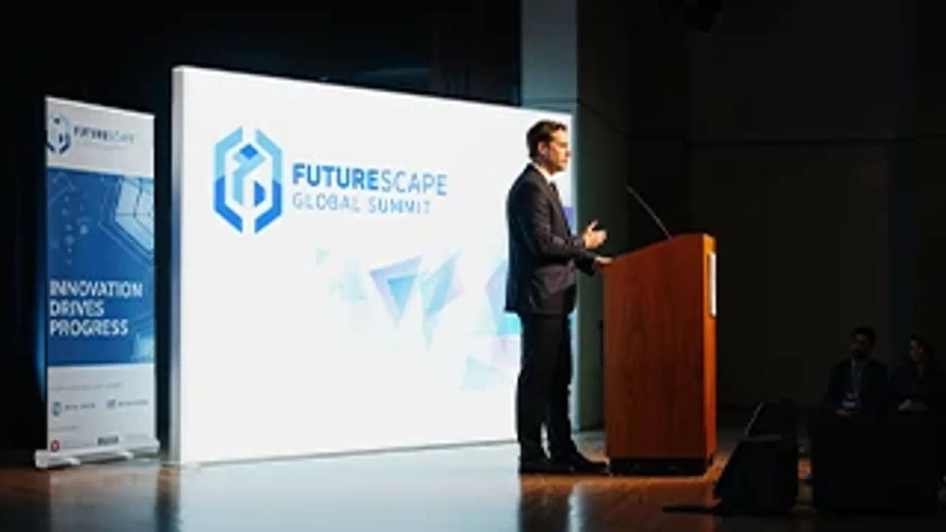 Large custom event backdrop providing professional branding for a global summit keynote speaker.